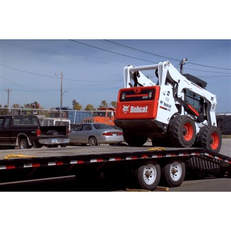 loading a skid steer onto a flat bed|mini flatbed truck haul.